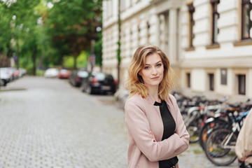 Fototapeta na wymiar Attractive young blond woman in a quiet street