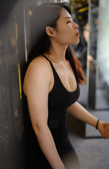 A Chinese young lady has weights training indoors.