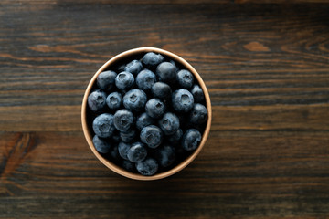 Fresh organic blueberries in a paper cup