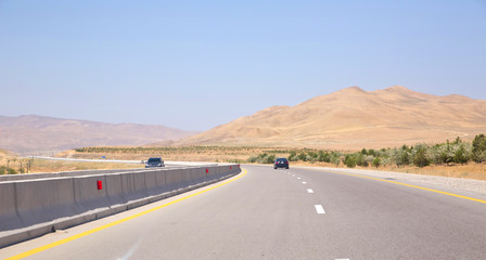 endless scenic road across somewhere in Azerbaijan . Empty asphalt road across vast hilly landscape of Azerbaijan .