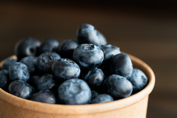 Macro shot of organic blueberries in a paper cup