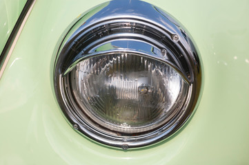Beautiful Round Chromed Headlamp Background of a Retro Car Close-Up.