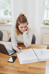 Young businesswoman working on office paperwork