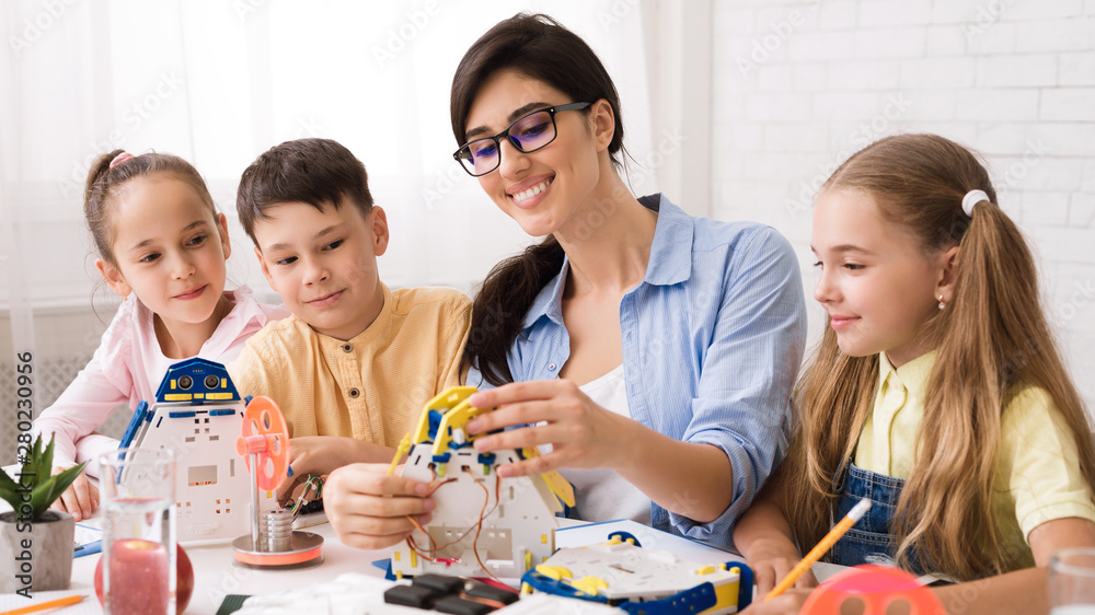 Poster stem education. pupils creating robots with teacher