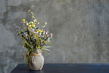 pink and yellow artificial plants with a copy area on a white wood floor