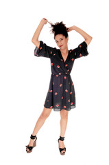 Gorgeous multi-racial woman standing pulling her hair