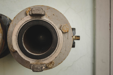 old rusted fire pipes on white wall