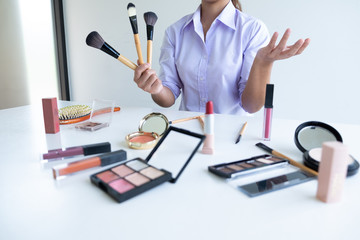 woman showing beauty cosmetic product and broadcast to social network by internet, beauty blogger...