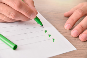 Concept of hand with marker pen completing a questionnaire elevated