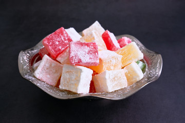 Turkish delight. Flavoured Turkish delights on isolated surface
