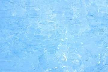 Tinted plaster surface of the sky blue colour with white splashes, texture, horizontal, top view