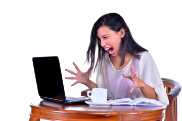 Stressed businesswoman shouting loudly at laptop
