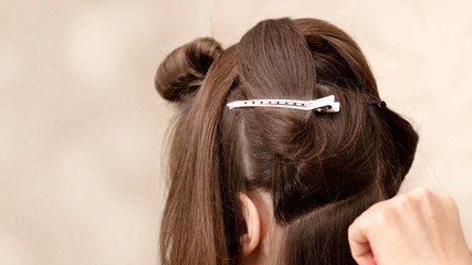 Fototapeta premium Hairdresser cuts a girl with long hair. Haircut on long hair. Hairstyle on long hair. Bride's morning. Visagiste prepares the girl for the holiday. Preparing for the holiday.