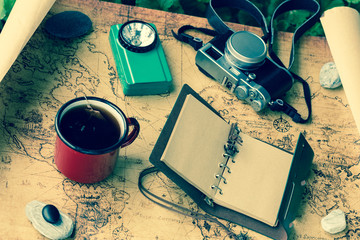 a map with a travel notebook and travel equipment in a retro style. Journey plan