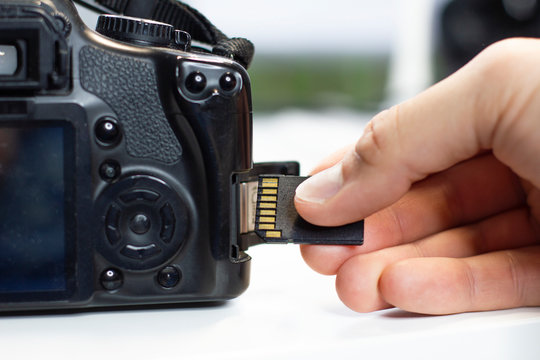Inserting sd card by hand in a camera, insert flash card