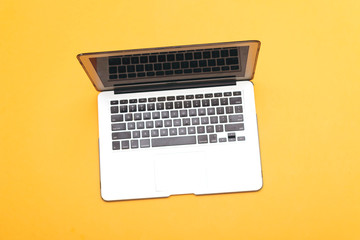 Fototapeta na wymiar modern laptop isolated on yellow background