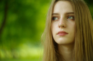 Fototapeta premium beautiful young blonde with long flowing hair and blue eyes in an old castle