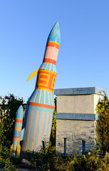 abandon rocket toy in underbrush in blue sky view