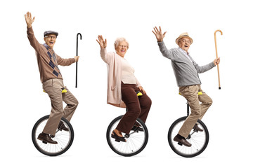 Senior people riding unicycles and smiling at the camera © Ljupco Smokovski