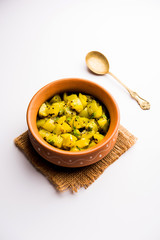 Lauki/doodhi ki sookhi Sabji also known as bottle gourd dry vegetable recipe. served in a bowl or karahi. selective focus
