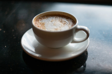 Coffee in mug with saucer