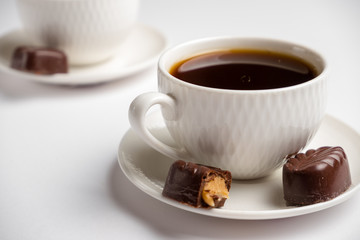white cup for coffee with sweets on a white background