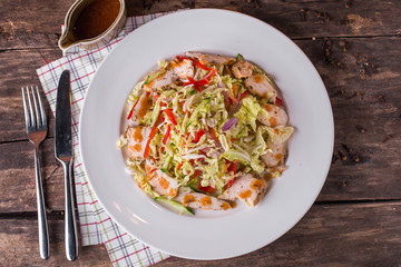 Vegetable Salad with hiken on white plate and rustic table