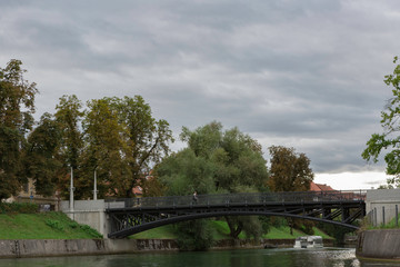 Fototapeta premium Ljubljana,Slovenia,6,2016: Street, river, bridges with dragons, magical city.