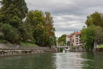 Fototapeta na wymiar Ljubljana,Slovenia,6,2016: Street, river, bridges with dragons, magical city.