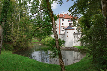 Fototapeta na wymiar Snežnik Castle,Slovenia,10,2016: idyllic spot, composed of trees and a pond