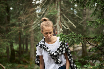 Hipster woman walking in the forest