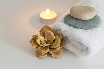 white towels with candle,flower,stones and soap for hotel spa concept.