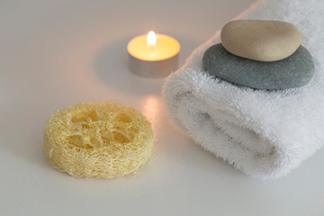 Fototapeta na wymiar white towels with candle,flower,stones and soap for hotel spa concept.