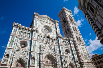 Fototapeta premium The Giotto Campanile and Florence Cathedral consecrated in 1436 against a beautiful blue sky