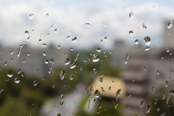 Cloudy rainy day in summer in Moscow city (Russia). Sudden cold snap, drops on window glass and cityscape