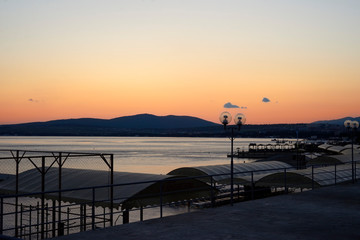 sunset illuminates a bay in the city