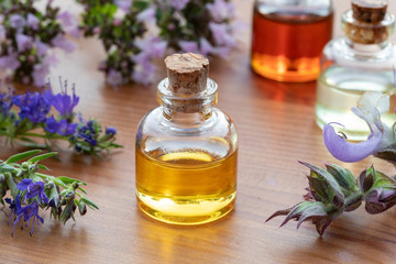Bottles of essential oil with hyssop, clary sage, oregano