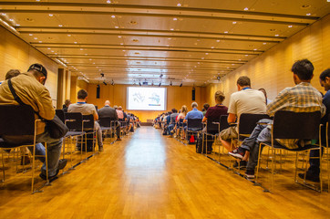 Huge audience people paying attention to a scientific presentation in an European conference