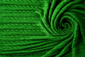 Texture of knitted green fabric. Crocheted abstract background.