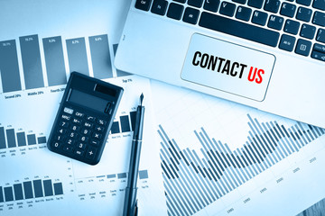 Graphs, charts and keyboard with text CONTACT US