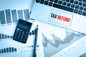 Graphs, charts and keyboard with text TAX REFUND