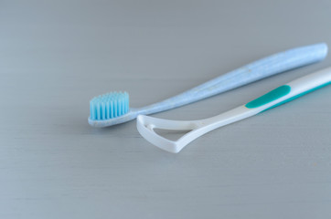 Oral hygiene health concept. Closeup dental tools toothbrush and tongue cleaner