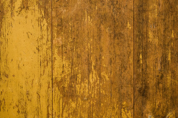 Grunge old yellow painted planks with wood texture .