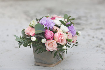 Flower arrangement in a box with spray pink roses, succulent, eustoma, white hypericum, eucaliptus.
