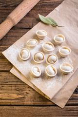 Raw Russian traditional dumplings on wooden background