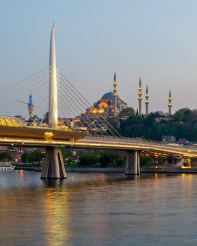 Golden Horn Metro Bridge, Halic Bridge overlapping Suleymaniye Mosque before sunset, Istanbul, Turkey