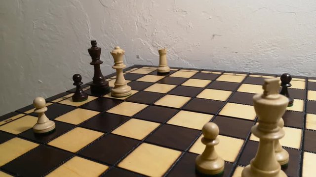 close up hand using white queen checkmate the black king