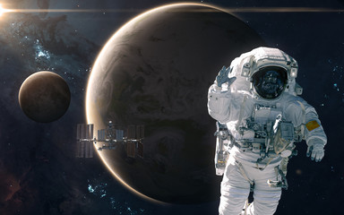 Fototapeta na wymiar Astronaut and ISS on background of Earth and Moon. Solar system. Science fiction. Elements of this image furnished by NASA