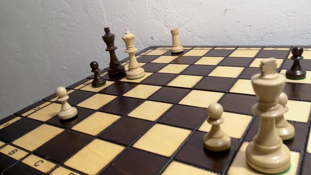 close up hand using white queen checkmate the black king