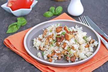 Pilaf with chanterelles and chicken on brown clay plate. Cooking wild mushrooms. Mushroom season recipes.